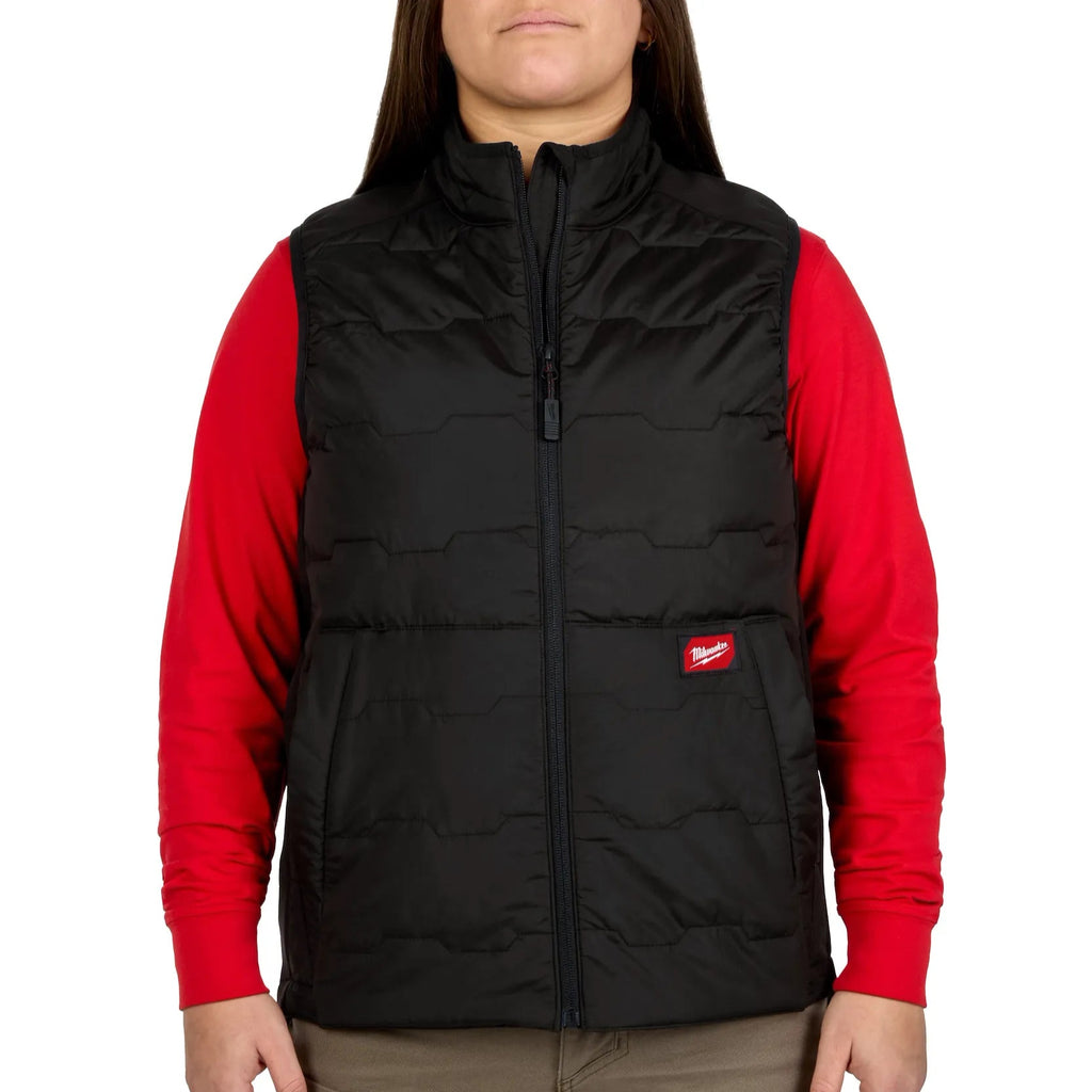 Person wearing a black FreeFlex vest over a red shirt with brand logo.