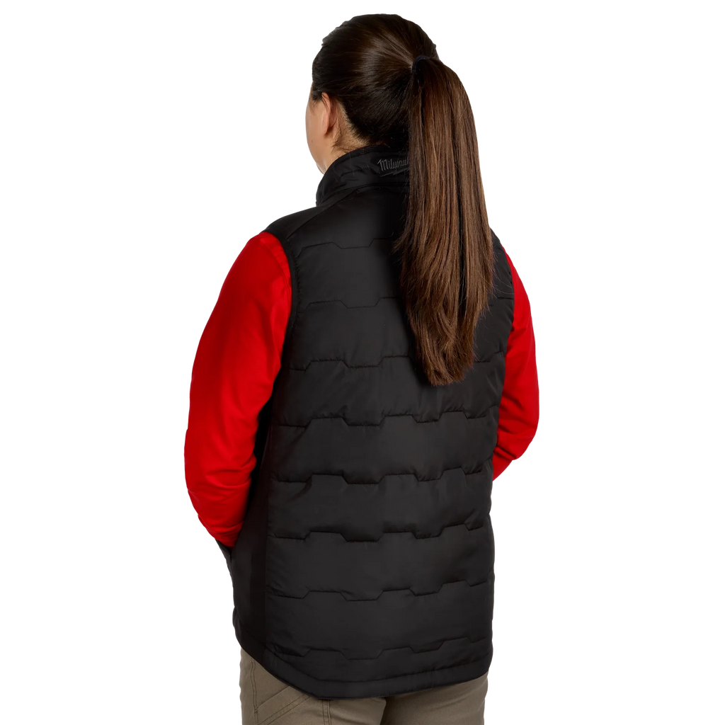 Person wearing a black puffer vest over a red shirt on a white background